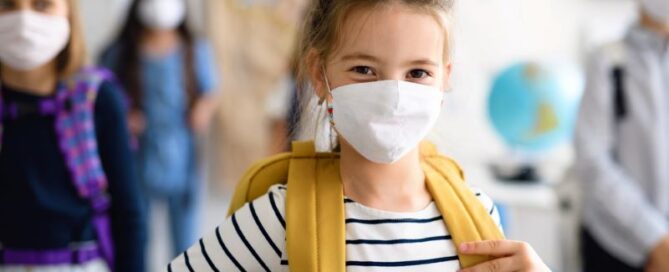 child wearing mask returning to in-person school