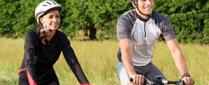 man and woman riding mountain bikes