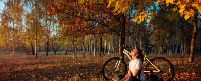 Woman sitting outside in fall sunshine