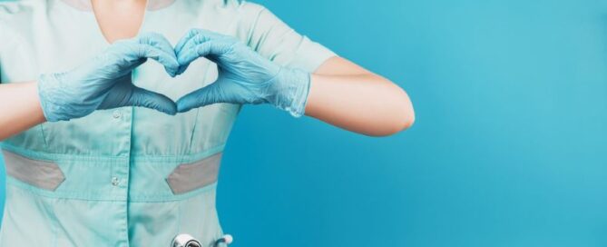 Masked docotr showing heart sign with hands