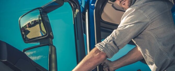 Male truck driver exiting vehicle